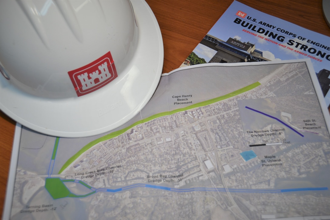 A map of proposed work for the Lynnhaven Inlet Federal Navigation Project for the City of Virginia Beach is flanked by a U.S. Army Corps of Engineers hard hat and USCAE literature on a desk at Fort Norfolk, Virginia, April 8, 2019