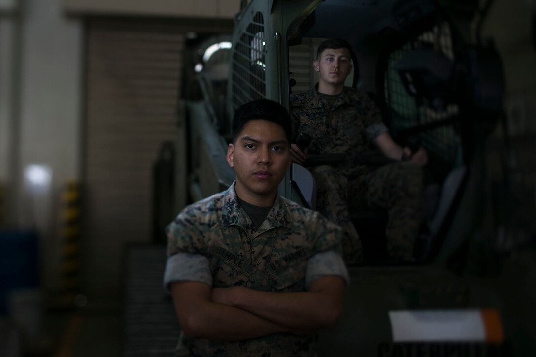 Lance Cpl. Keven A. Temple, left, and Garrett R. Jolley, heavy equipment mechanics with Combat Logistics Battalion 31, move fork lifts into the garage for repairs at Camp Hansen, Okinawa, Japan, March 27, 2019. Temple, a native of Jacksonville, Florida, graduated from River City Science Academy in June 2016 before enlisting in January 2017. Temple joined the Marine Corps to follow his family legacy. Since joining the Marines, he has learned traits of good leadership, including dedication, team work and responsibility. Jolley, a native of Glenwood Spring, Colorado, graduated from Coal Ridge High School in May 2015 before enlisting in August 2018. He joined to experience team work, dedication and culture. Since enlisting he has learned more about respect to others and understanding people from different backgrounds, units and culture. (U.S. Marine Corps photo by Lance Cpl. Cameron E. Parks/Released)