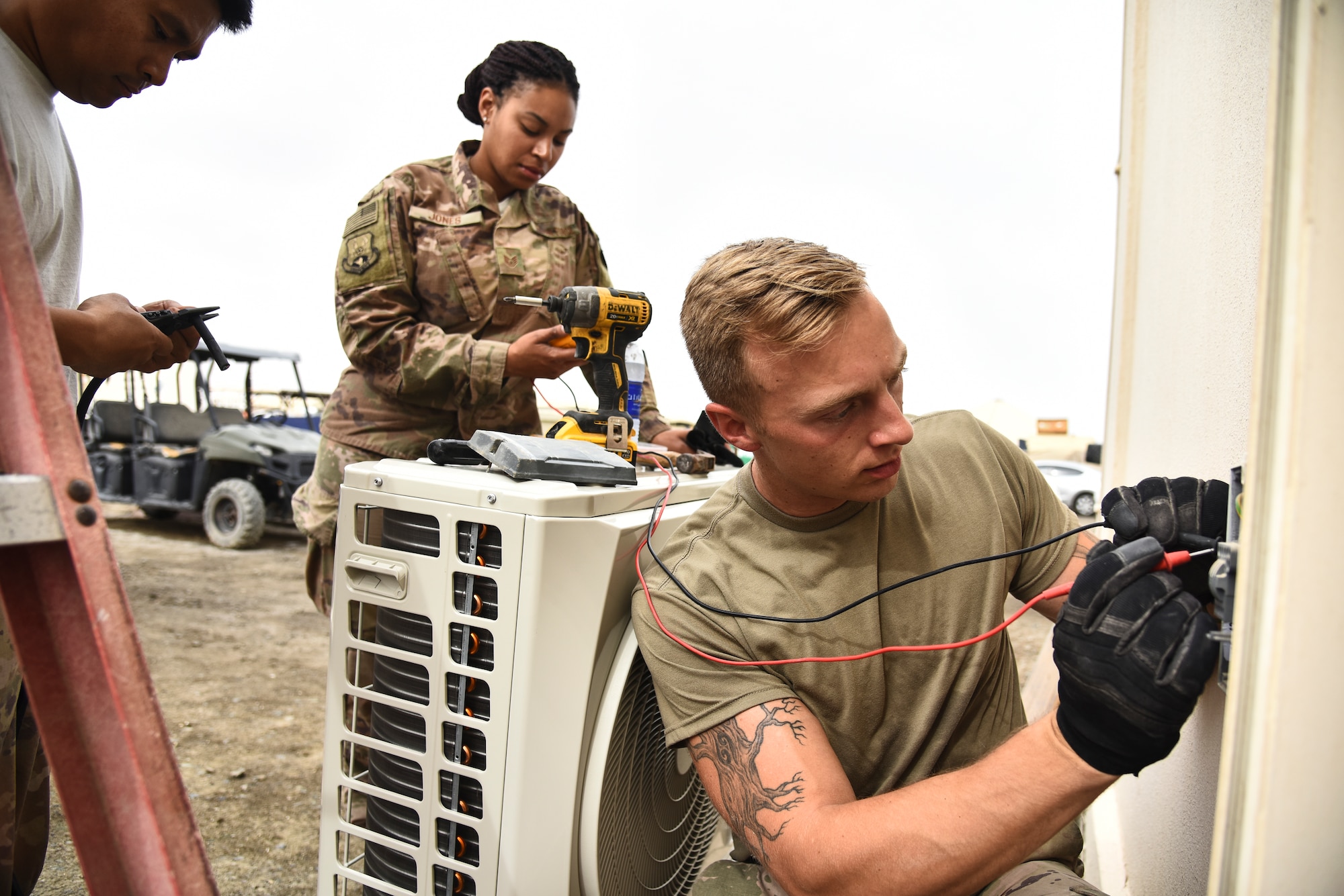 380th Expeditionary Civil Engineer Squadron Heating, Ventilation, Air Conditioning and Refrigeration journeymen, verify power in preparation of replacing an A/C unit at Al Dhafra Air Base, United Arab Emirates, April 8, 2019. HVAC Airmen maintain and repair HVAC equipment and systems. (U.S. Air Force photo by Senior Airman Mya M. Crosby)