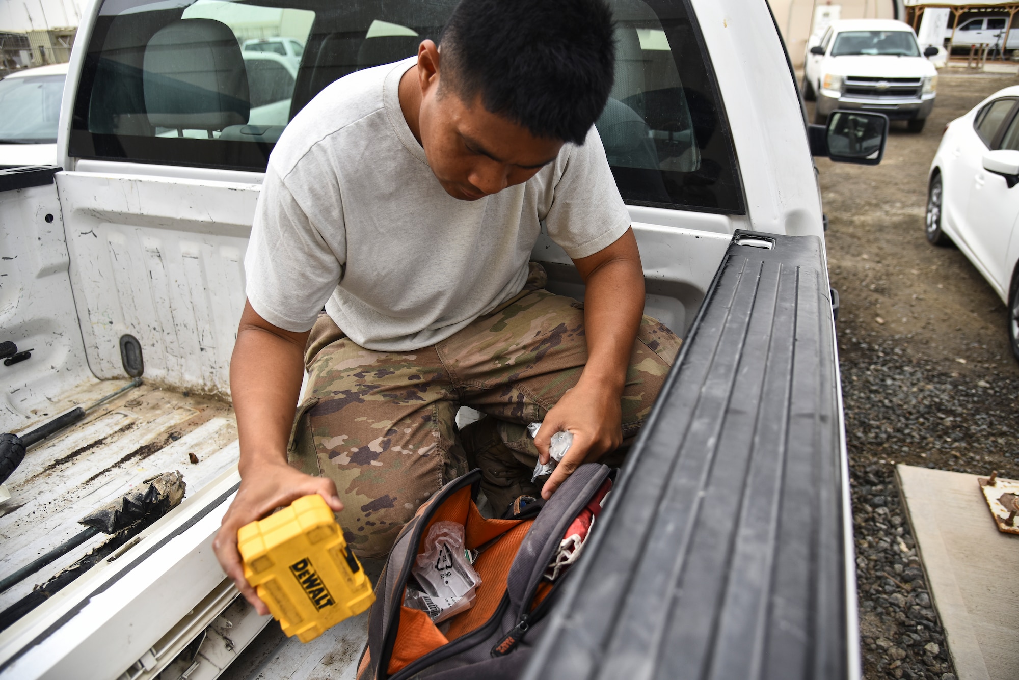 Staff Sgt. Ricky Hipolito, 380th Expeditionary Civil Engineer Squadron Heating, Ventilation, Air Conditioning and Refrigeration journeyman, searches through his tool bag at Al Dhafra Air Base, United Arab Emirates, April 8, 2019. HVAC Airmen perform recurring maintenance and seasonal overhaul on systems and components. (U.S. Air Force photo by Senior Airman Mya M. Crosby)