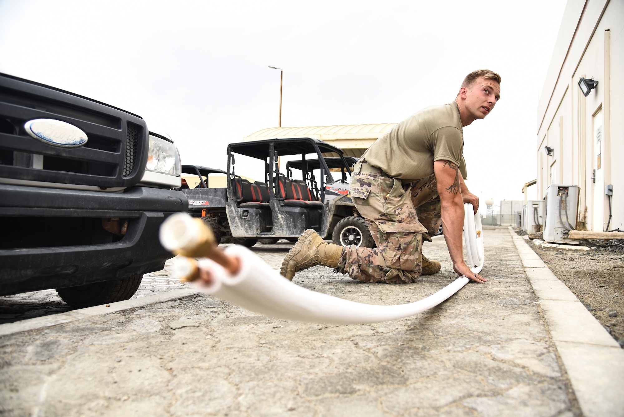 Staff Sgt. Nicholas Mannion, 380th Expeditionary Civil Engineer Squadron Heating, Ventilation, Air Conditioning and Refrigeration journeyman prepares line sets for an A/C installation at Al Dhafra Air Base, United Arab Emirates, April 8, 2019. HVAC Airmen perform recurring maintenance and seasonal overhaul on systems and components. (U.S. Air Force photo by Senior Airman Mya M. Crosby)