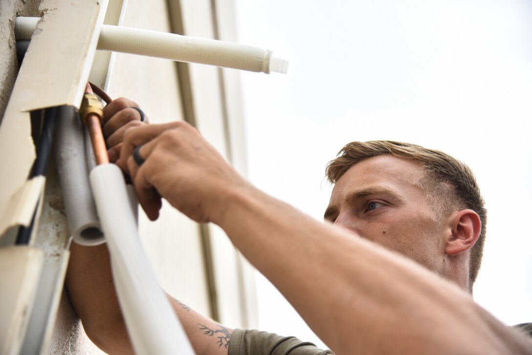 Staff Sgt. Nicholas Mannion, 380th  Expeditionary Civil Engineer Squadron Heating, Ventilation, Air Conditioning and Refrigeration journeyman prepares line sets for an A/C installation at Al Dhafra Air Base, United Arab Emirates, April 8, 2019. HVAC Airmen monitor systems operation to ensure efficiency and compliance technical orders, manufacturer handbooks, local procedures, codes, and directives. (U.S. Air Force photo by Senior Airman Mya M. Crosby)