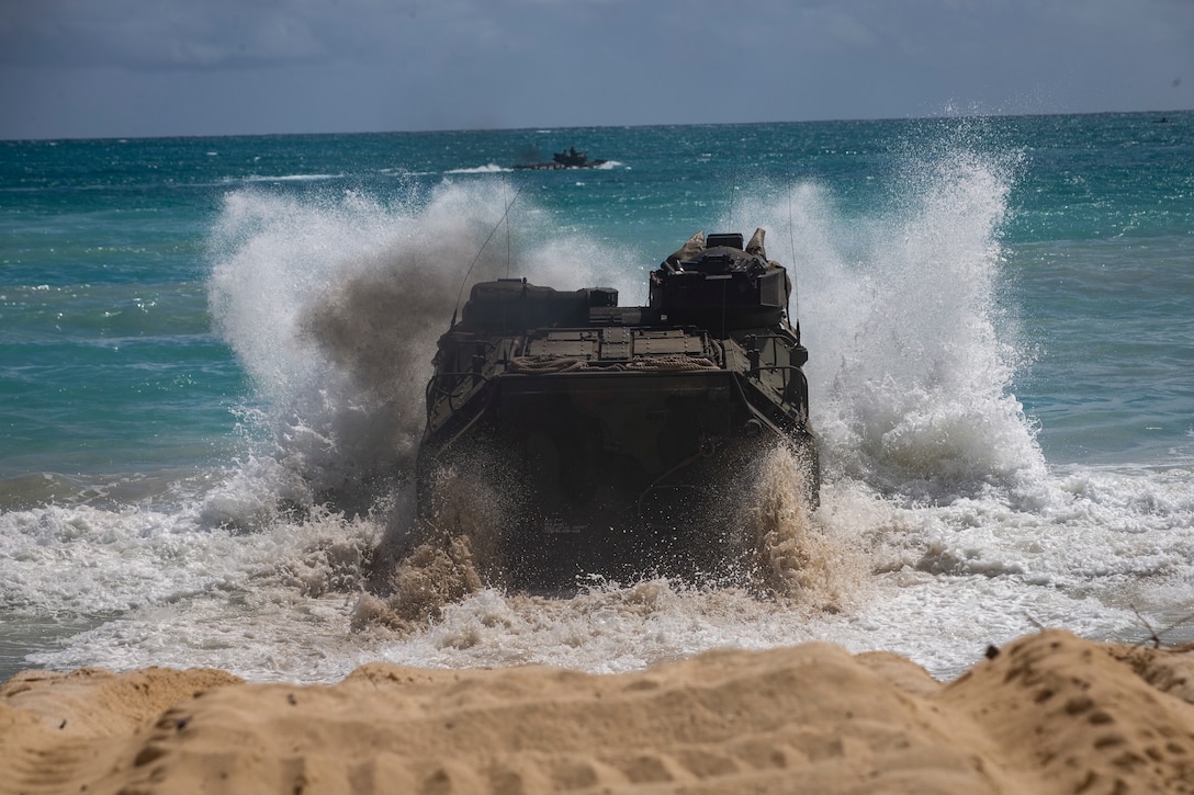 A U.S. Marine Corps amphibious assault vehicle assigned to Combat Assault Company, 3d Marine Regiment, crashes into the tides during an amphibious assault exercise at Marine Corps Training Area Bellows, Marine Corps Base Hawaii, Apr. 9, 2019. The unit conducted a simulated beach assault to improve their lethality and cooperation, as a mechanized unit and force in readiness.