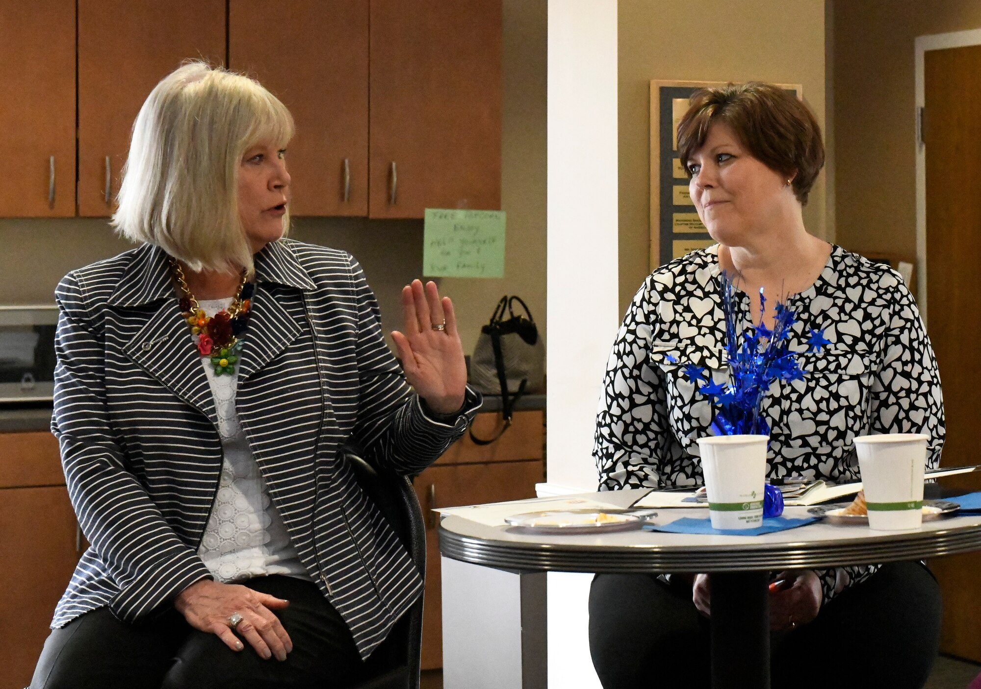 Terri Ann Naughton, director of psychological health for the 910th Airlift Wing, discusses the role of her position with Suzie Schwartz at the Kubli Morale and Wellness Center here, April 6, 2019.