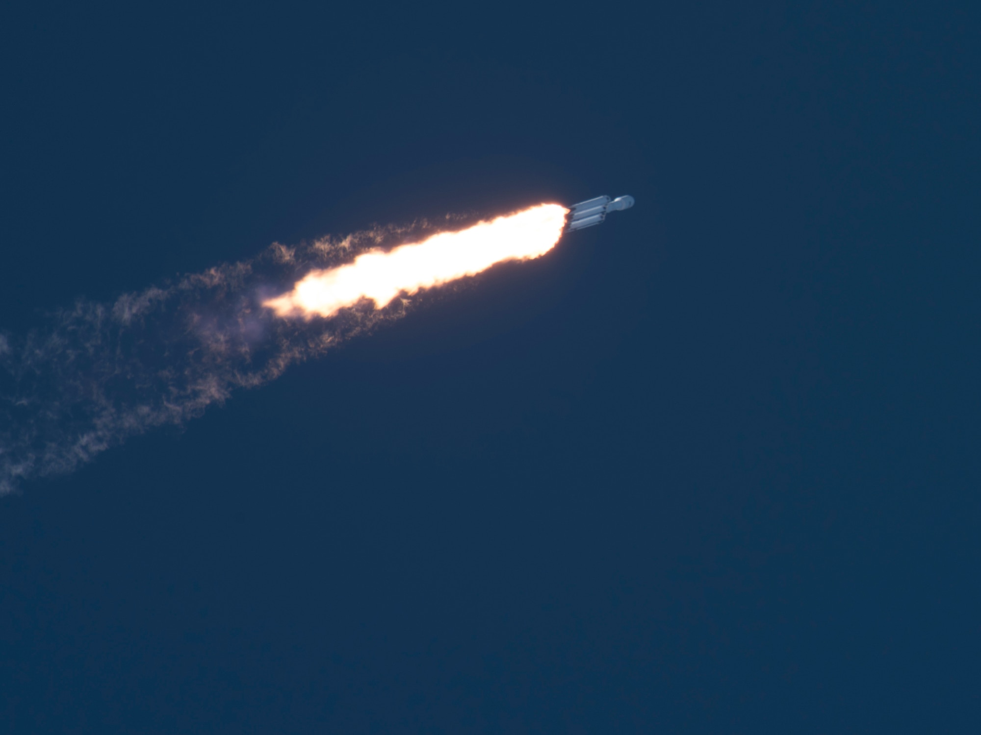 SpaceX's Falcon Heavy Arabsat 6A rocket leaves the Earth's atmosphere after launching from Space Launch Complex 39A on April 12, 2019 at Kennedy Space Center, Fla. This marks the second launch of the Falcon Heavy rocket; the most powerful space vehicle flying today. (U.S. Air Force photo by 2nd Lieutenant Alex Preisser)