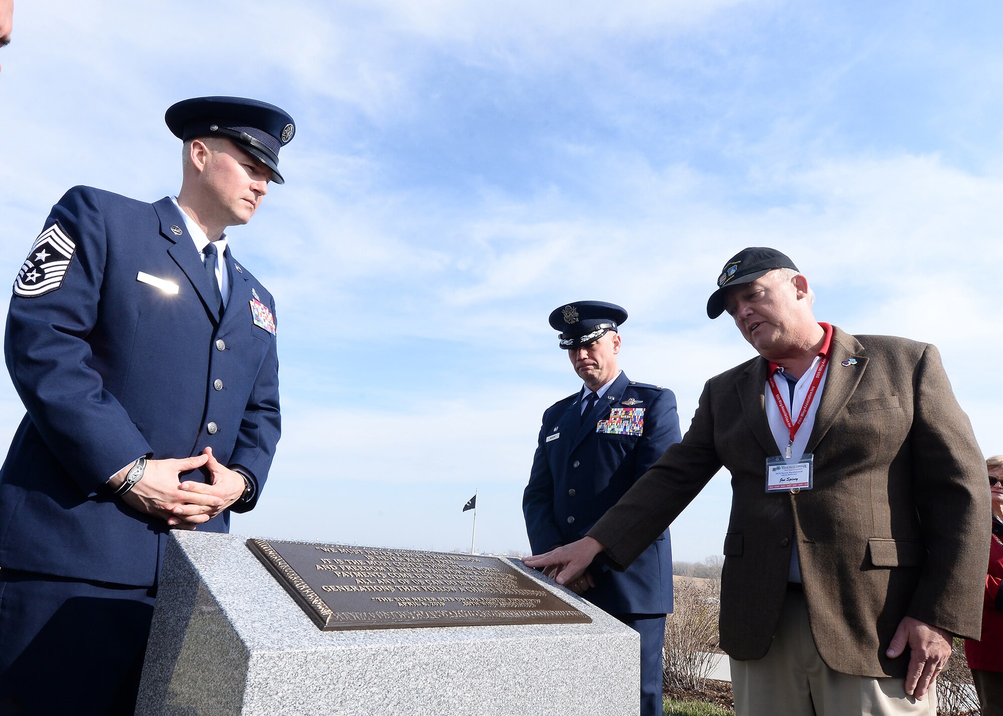 U.S. Air Force Chief Master Sgt. Brian Thomas, 55th Wing command chief, left, U.S. Air Force Col. Michael Manion, 55th Wing commander, and Joe Spivey, 55th Wing Association president and retired Air Force colonel, unveil the new monument dedicated to all of the past, present and future members of the 55th Wing during a ceremony at the Omaha National Cemetery in Omaha on April 6, 2019. This is the second monument the association has dedicated to the 55th Wing with the first being located at the Air Force Museum at Wright-Patterson Air Force Base, Ohio. (U.S. Air Force photo by Charles Haymond)