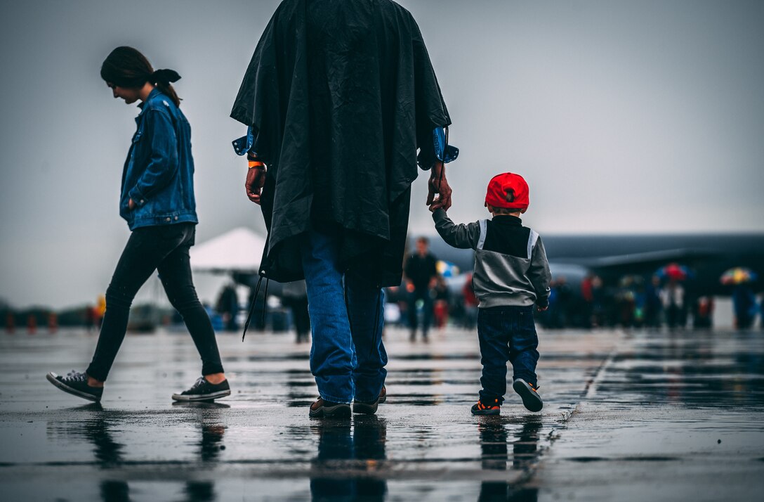 Airshow guests walk in the rain during the Heart of Texas Airshow April 7, 2019. Despite the inclement weather, guests waited until the weather cleared to watch the aerial performances. (U.S. Air Force Photo by Senior Airman Alexander Cook)