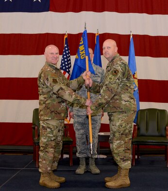 507th Air Refueling Wing commander, Col. Miles Heaslip, hands the command guidon to Lt. Col. Karwin Weaver, during the 507th Maintenance Group assumption of command ceremony at Tinker Air Force Base, Oklahoma, April 7, 2019. (U.S. Air Force photo by Tech. Sgt. Samantha Mathison)