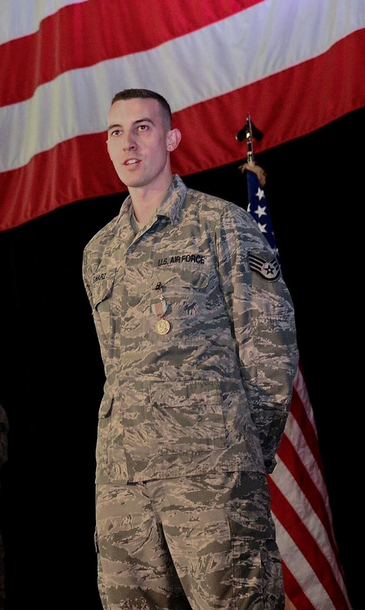 Staff Sgt. Greggory Swarz stands at ease after receiving the Airman's Medal at Royal Air Force Lakenheath, United Kingdom from Gen. Frank Gorenc, then Commander U.S. Air Forces in Europe; Commander, U.S. Air Forces Africa; Commander, NATO Allied Air Command; and Director, Joint Air Power Competence Centre. Swarz pulled three French airmen out of a burning Greek F-16 that crashed on the flight line during a multinational exercise in Spain Jan. 26, 2015. (U.S. Air Force photo)
