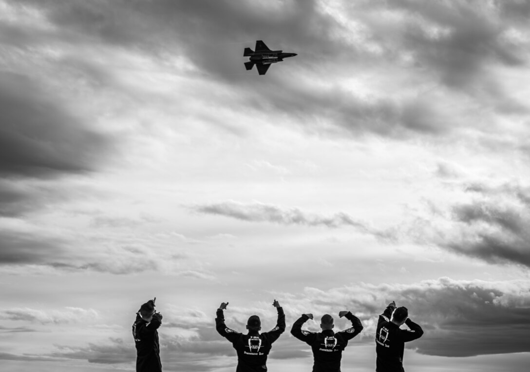 F-35 Demonstration Team members celebrate as Capt. Andrew “Dojo” Olson performs aerial maneuvers in an F-35A Lightning II during the Heritage Flight Training Course March 2, 2019, at Davis-Monthan Air Force Base, Ariz. The team is now officially certified to fly their demonstration and will perform at more than 17 air shows around the United States and Canada during the 2019 season. (U.S. Air Force photo by Senior Airman Alexander Cook)