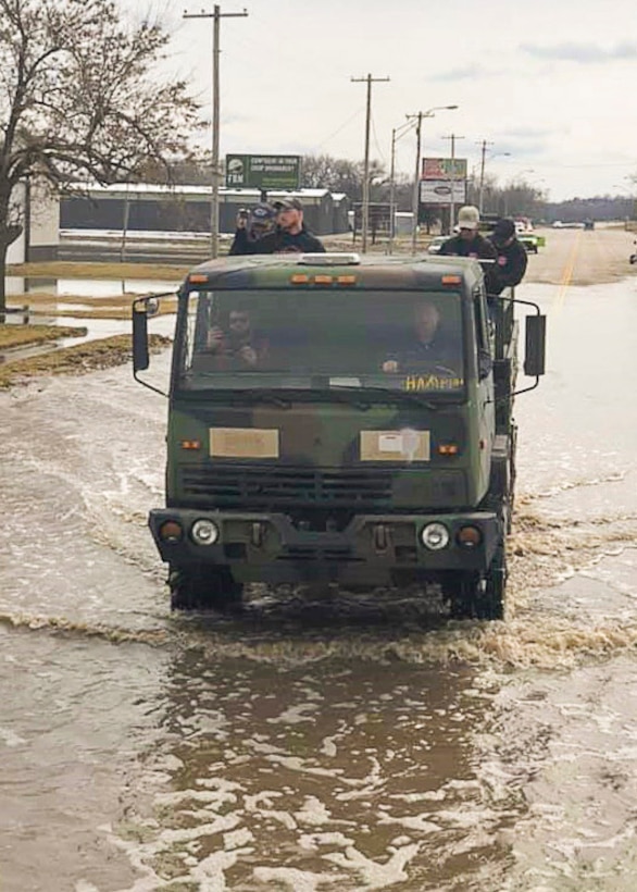 Lewis Sieber, fire equipment manager of the Nebraska Forest Service navigates through flood water searching for stranded people in a six-wheeled drive cargo truck issued through the DoD Firefighter Program. Photo provided by the Nebraska Forest Service