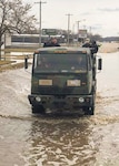 Lewis Sieber, fire equipment manager of the Nebraska Forest Service navigates through flood water searching for stranded people in a six-wheeled drive cargo truck issued through the DoD Firefighter Program. Photo provided by the Nebraska Forest Service