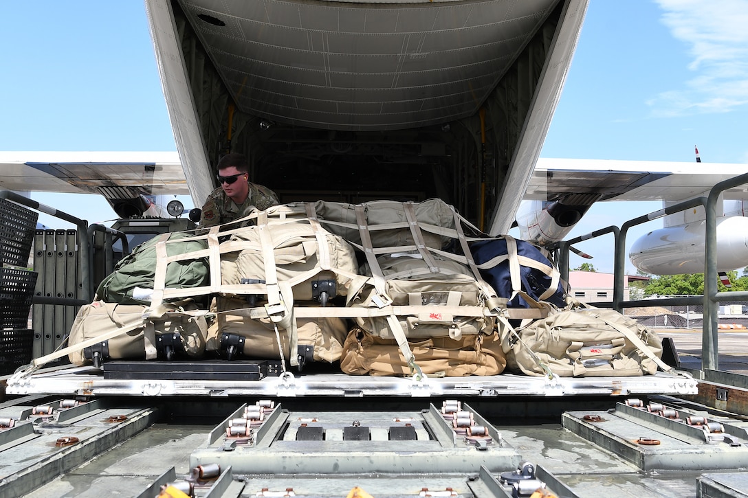 U.S. Air Force Staff Sgt. Drayton Callen, 81st Logistics Readiness Squadron deployment training NCO in charge, unloads cargo off of a U.S. Coast Guard HC-130J in support of exercise Neptune Guardian on Keesler Air Force Base, Mississippi, April 5, 2019. The 81st LRS acted as a one-stop shop for ground and air transportation as well as munition requirements for joint exercise Neptune Guardian between the U.S. Coast Guard and U.S. Navy. (U.S. Air Force photo by Senior Airman Suzie Plotnikov)