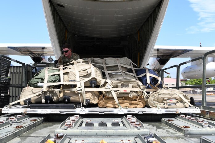 U.S. Air Force Staff Sgt. Drayton Callen, 81st Logistics Readiness Squadron deployment training NCO in charge, unloads cargo off of a U.S. Coast Guard HC-130J in support of exercise Neptune Guardian on Keesler Air Force Base, Mississippi, April 5, 2019. The 81st LRS acted as a one-stop shop for ground and air transportation as well as munition requirements for joint exercise Neptune Guardian between the U.S. Coast Guard and U.S. Navy. (U.S. Air Force photo by Senior Airman Suzie Plotnikov)