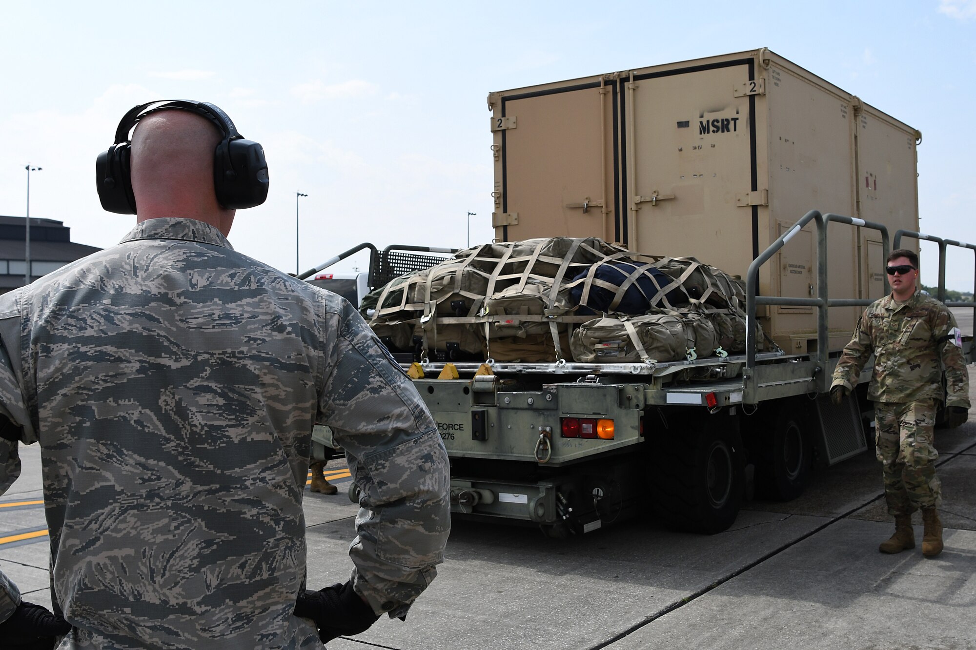 U.S. Air Force Tech. Sgt. Brian Teachout, 81st Logistics Readiness Squadron Small Air Terminal NCO in charge, and Staff. Sgt. Drayton Callen, 81st LRS deployment training NCO in charge, wait for a forklift to unload cargo in support of exercise Neptune Guardian on Keesler Air Force Base, Mississippi, April 5, 2019. The 81st LRS acted as a one-stop shop for ground and air transportation as well as munition requirements for joint exercise Neptune Guardian between the U.S. Coast Guard and U.S. Navy. (U.S. Air Force photo by Senior Airman Suzie Plotnikov)