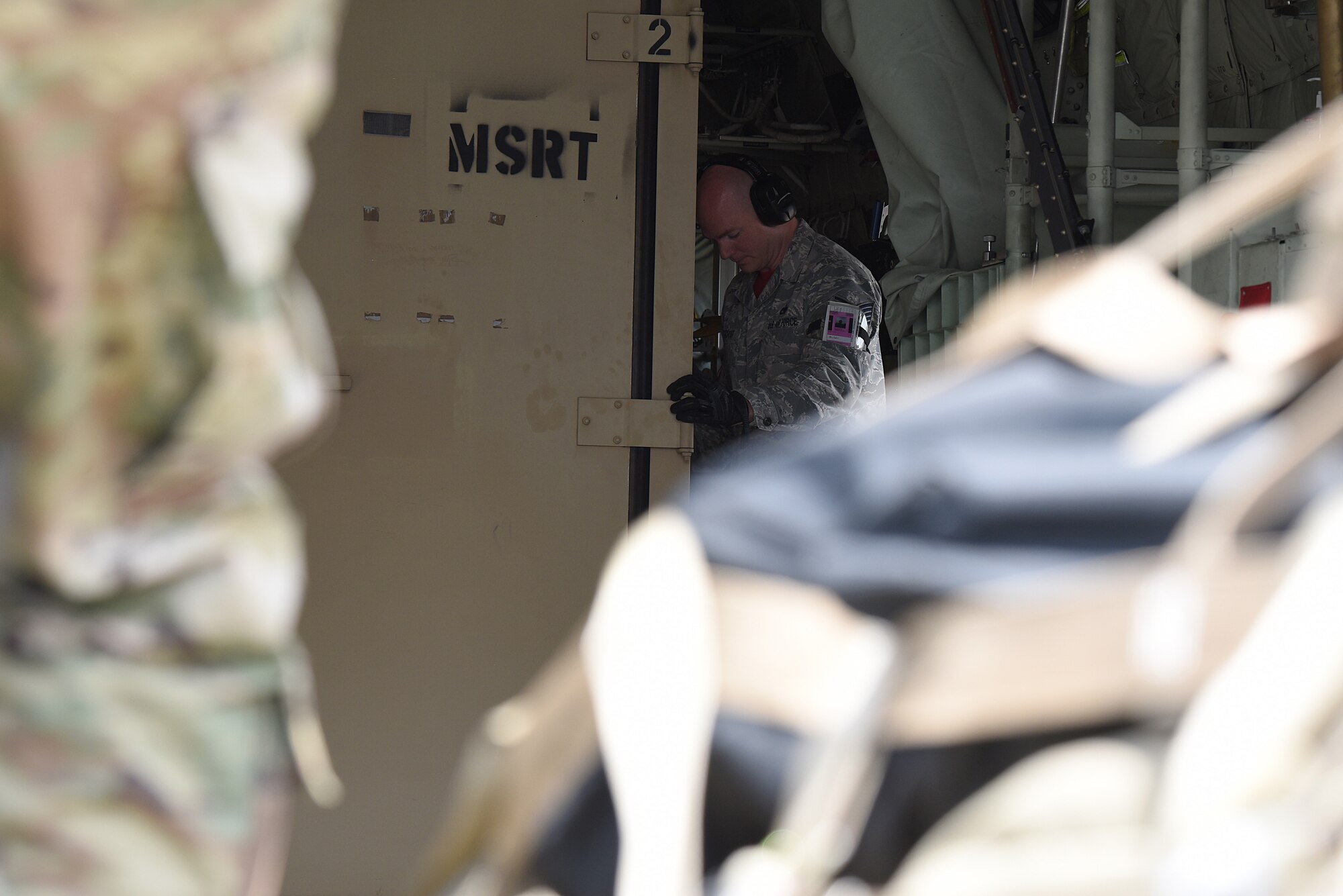 U.S. Air Force Tech. Sgt. Brian Teachout, 81st Logistics Readiness Squadron Small Air Terminal NCO in charge, unloads cargo off of a U.S. Coast Guard HC-130J in support of exercise Neptune Guardian on Keesler Air Force Base, Mississippi, April 5, 2019. The 81st LRS acted as a one-stop shop for ground and air transportation as well as munition requirements for joint exercise Neptune Guardian between the U.S. Coast Guard and U.S. Navy. (U.S. Air Force photo by Senior Airman Suzie Plotnikov)