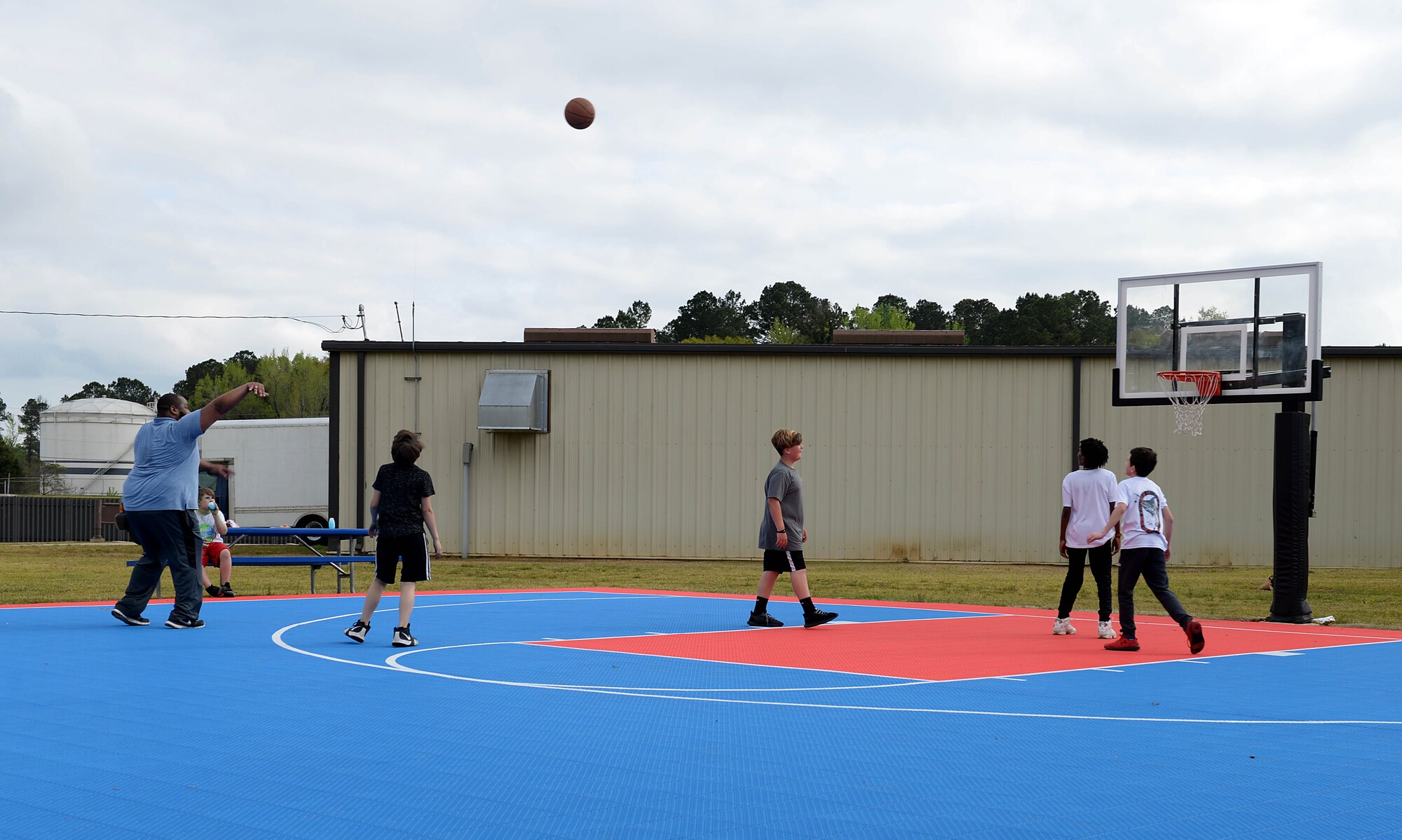 Andre Logan, 14th Force support Squadron, Child and Youth services Flight Chief, plays basketball with kids during the Youth Center’s Month of the Military Child kickoff, April 5, 2019, on Columbus Air Force Base, Miss. As the month celebration continues, families will be able to participate in many activities, such as a Purple Up Day and a Movie on the Lawn April 12, a and Spring Fling April 20 which will feature egg hunts for various age ranges, face painting, petting zoo, games bounce castles and more (U.S. Air Force photo by Airman Hannah Bean)