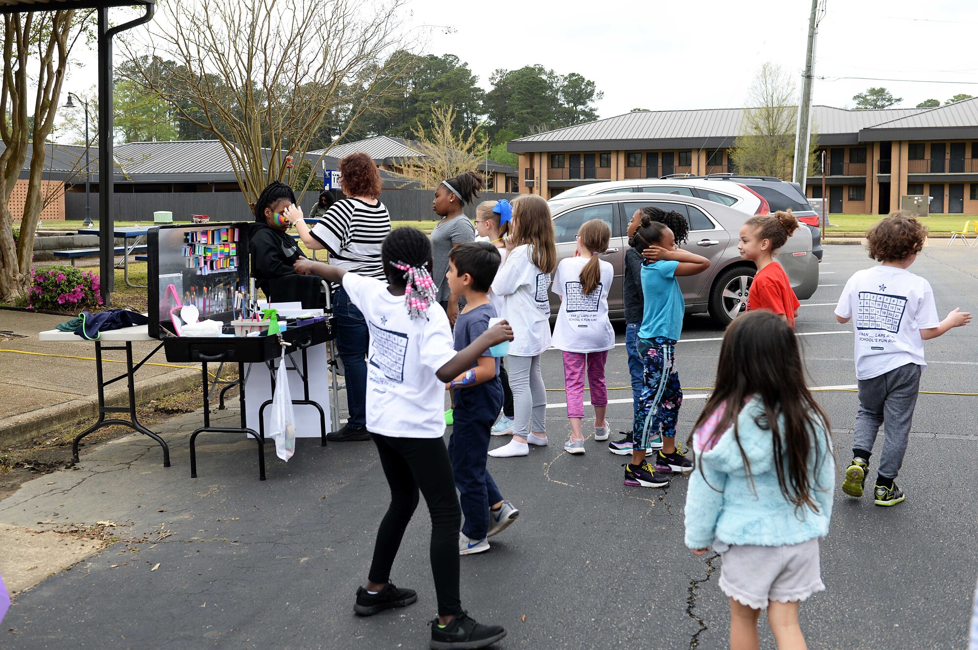 Children wait in line to get their faces painted during the Youth Center’s Month of the Military Child kickoff, April 5, 2019, on Columbus Air Force Base, Miss. Military children selflessly share their parents with the military as they endure separations, repeated deployments and navigating multiple moves. (U.S. Air Force photo by Airman Hannah Bean)