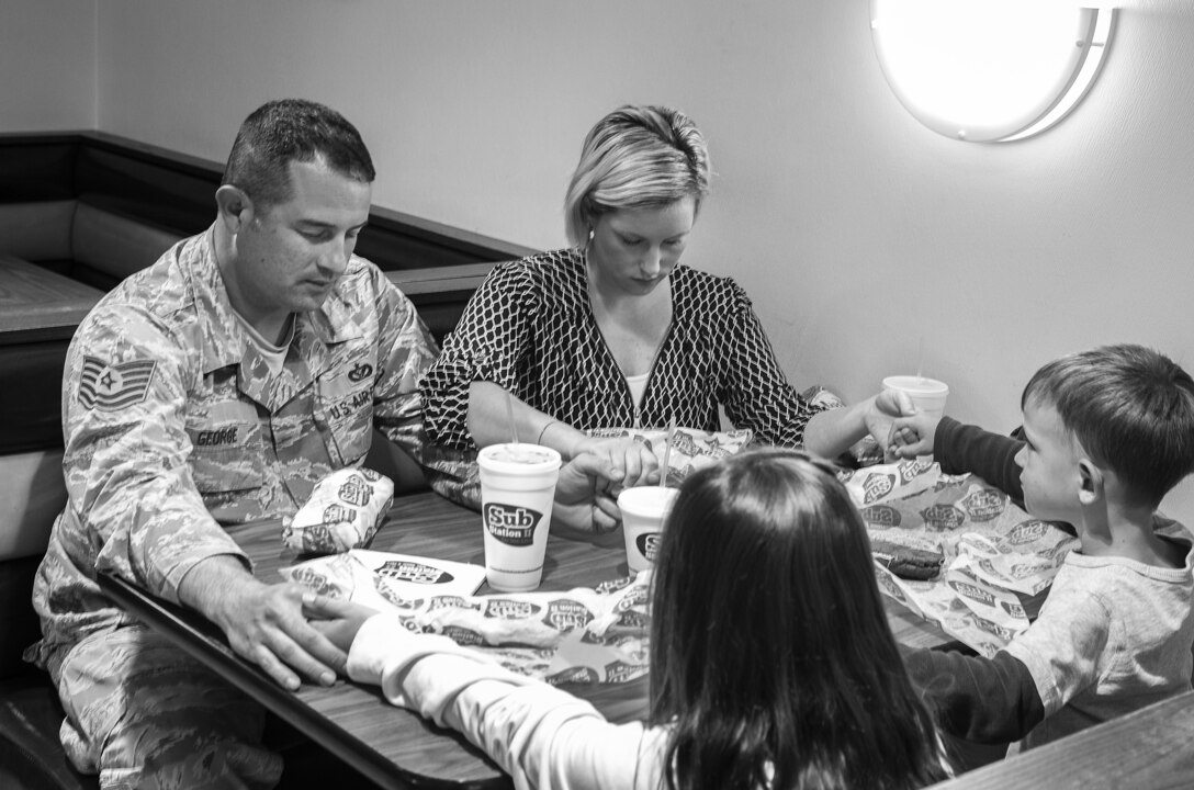 U.S. Air Force Tech. Sgt. Craig George, 20th Civil Engineer Squadron B-shift assistant chief of operations, says grace before having dinner with his family at Shaw Air Force Base, S.C., April 9, 2019.