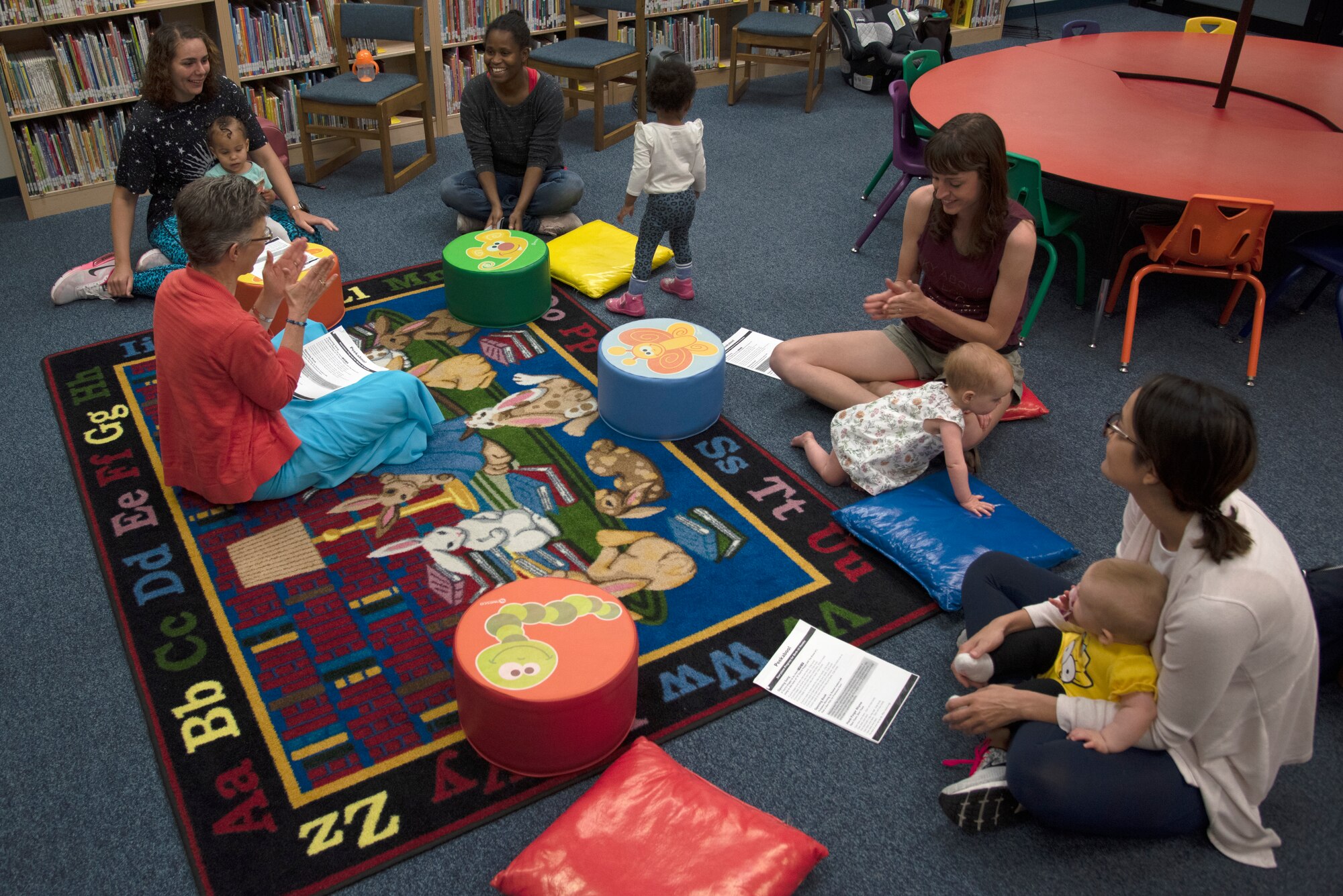 Kathryn Puckett, 56th Force Support Squadron senior library technician, sings with children and their parents during Babytime April 2, 2019, at Luke Air Force Base, Ariz.