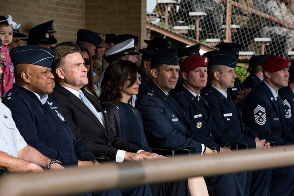 (Left) The honorable W. Stuart Symington, U.S. ambassador to the Federal Republic of Nigeria, watches Airmen march in a basic military training graduation parade April 5, 2019, at Joint Base San Antonio-Lackland, Texas. Symington is the grandson of William Stuart Symington Jr., the first Secretary of the Air Force.