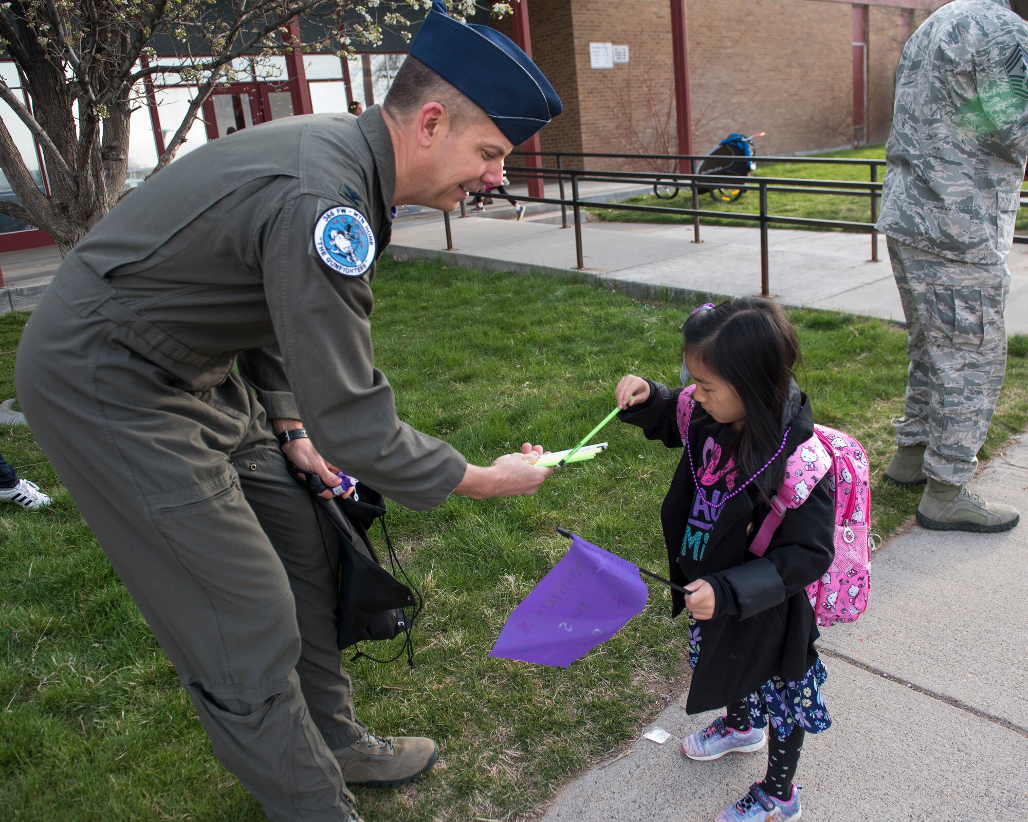 Col. Kurt Helphinstine, 366th Fighter Wing deputy commander of operations, hands out pencils to children in support of the Month of the Military Child April 12, 2019, at Mountain Home Air Force Base, Idaho. Military Children make sacrifices while their parents are out supporting the mission. (U.S. Air Force Photo by Airman 1st Class Hailey Bivens)