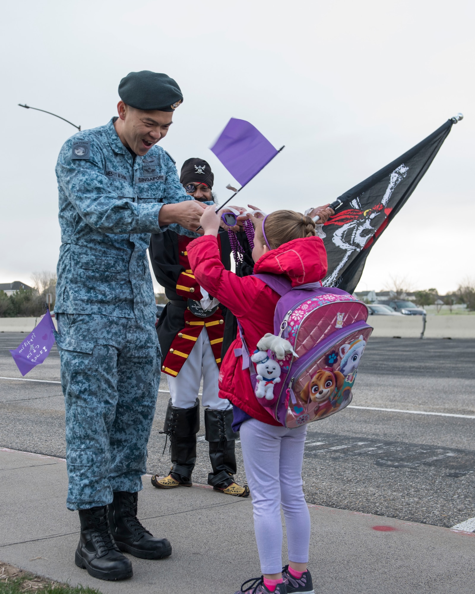 Maj. Theen Mun Chong, 428th Fighter Squadron senior maintenance officer, gives a child purple sunglasses April 12, 2019, at Mountain Home Air Force Base, Idaho. April is Month of the Military child and is a time to thank military children for their sacrifices. (U.S. Air Force Photo by Airman 1st Class Hailey Bivens)