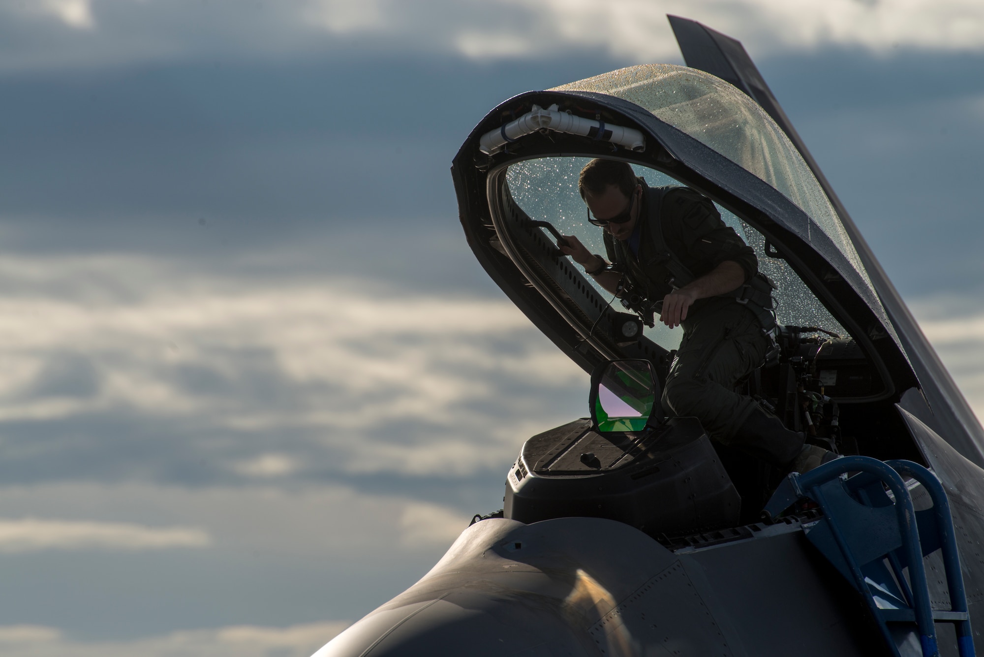 A 1st Fighter Squadron F-22 Raptor pilot stationed out of Joint Base Langley Eustis, Virginia, climbs into the cockpit during Gunfighter Flag, April 5, 2019 at Mountain Home Air Force Base, Idaho. The exercise Gunfighter Flag is held once a quarter to hone skills of 366th Fighter Wing Airmen. (U.S. Air Force photo by Airman 1st Class JaNae Capuno)