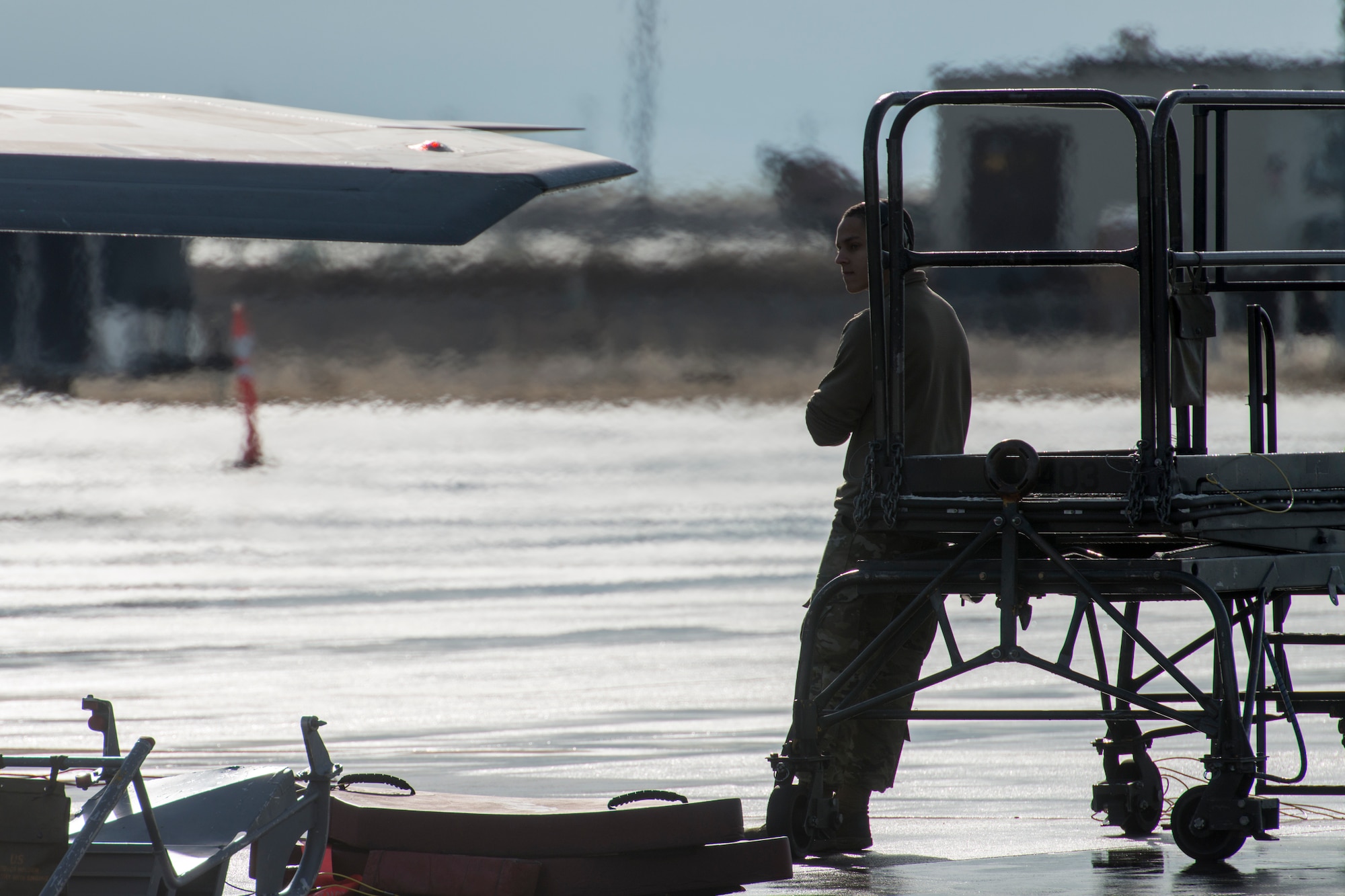 A 1st Fighter Squadron F-22 Raptor crew chief stationed out of Joint Base Langley Eustis, Virginia, leans against a B4 lifting platform during Gunfighter Flag, April 5, 2019 at Mountain Home Air Force Base, Idaho. The exercise Gunfighter Flag is held once a quarter to hone skills of 366th Fighter Wing Airmen. (U.S. Air Force photo by Airman 1st Class JaNae Capuno)
