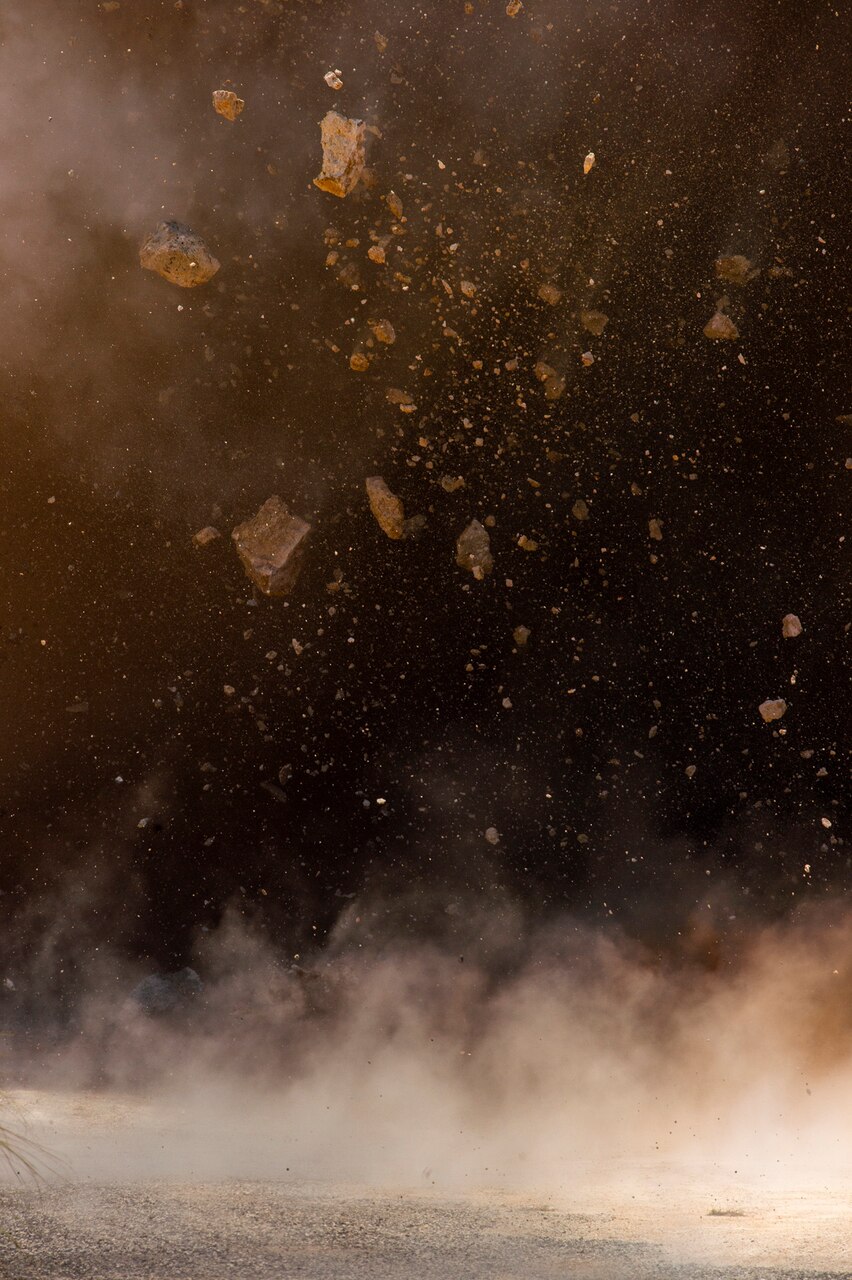 ANDERSEN AIR FORCE BASE, Guam (April 9, 2019) Debris from an explosion fills the air during joint quarry operations conducted by Sailors assigned to Naval Mobile Construction Battalion 133 (NMCB) and Airmen assigned to 554th Red Horse Squadron at Anderson Air Force Base’s quarry. NMCB conducted the demolition in order to maintain proficiency in blast operations that support construction and repair efforts in the region. NMCB-133, provides expeditionary construction and engineering capabilities that includes maintenance and operation of expeditionary bases and facilities, tactical sustainment bridging, humanitarian assistance through construction civic action details and civic action teams and theater disaster response capabilities in the U.S. 7th Fleet area of operations.