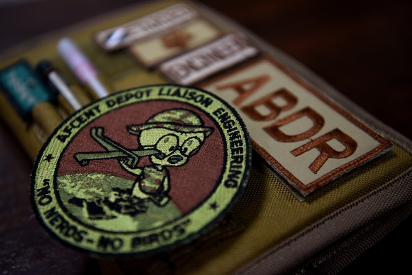 The unofficial unit Air Force Central Command Depot Liaison Engineering patch rests on a desk within the 380th Expeditionary Maintenance Group April 11, 2019.