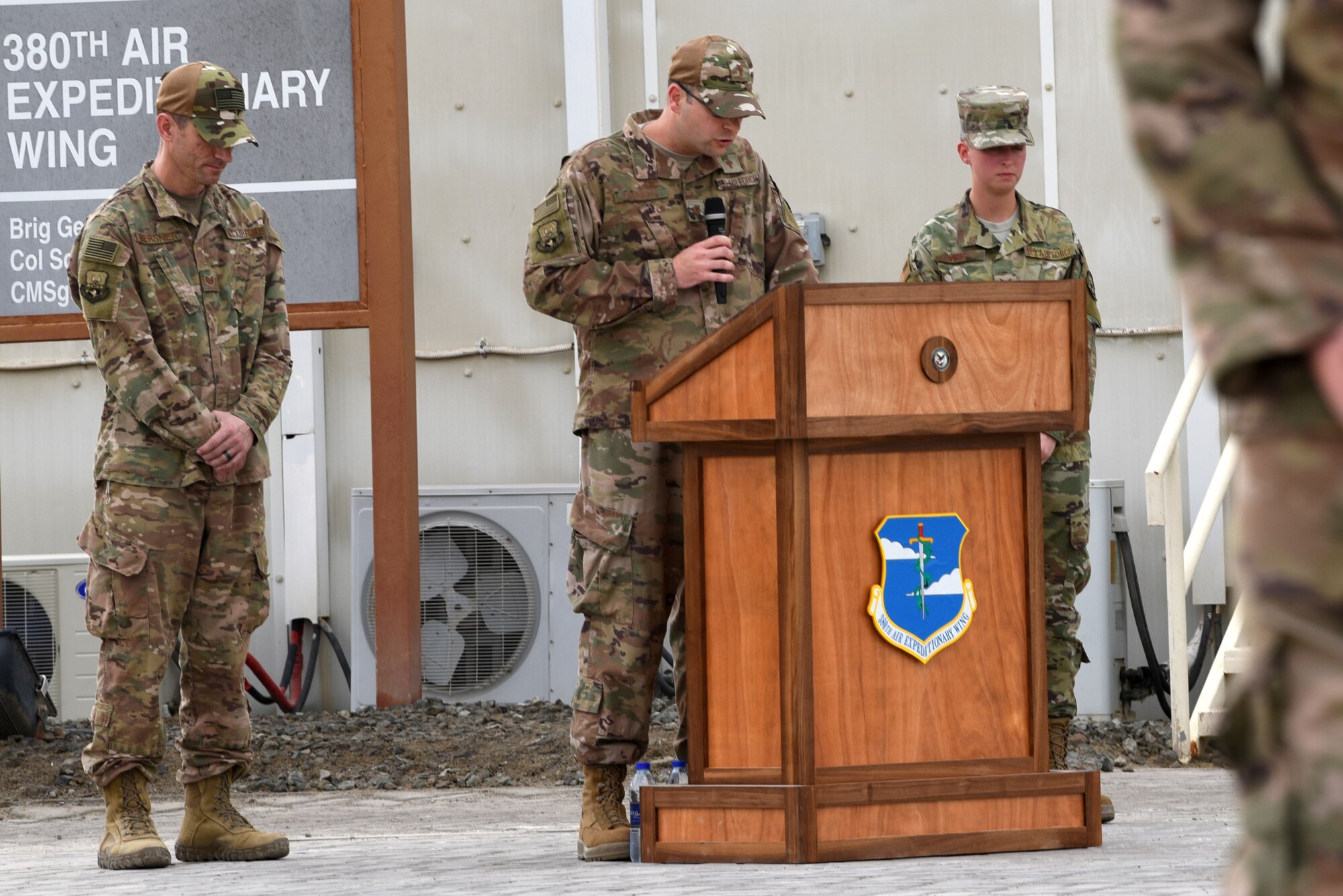 Members bow their heads as Chaplin Maj. Peter Landers, 380th Air Expeditionary Wing, delivers an invocation prior to a monthly ceremony on Al Dhafra Air Base, United Arab Emirates, April 5, 2019.