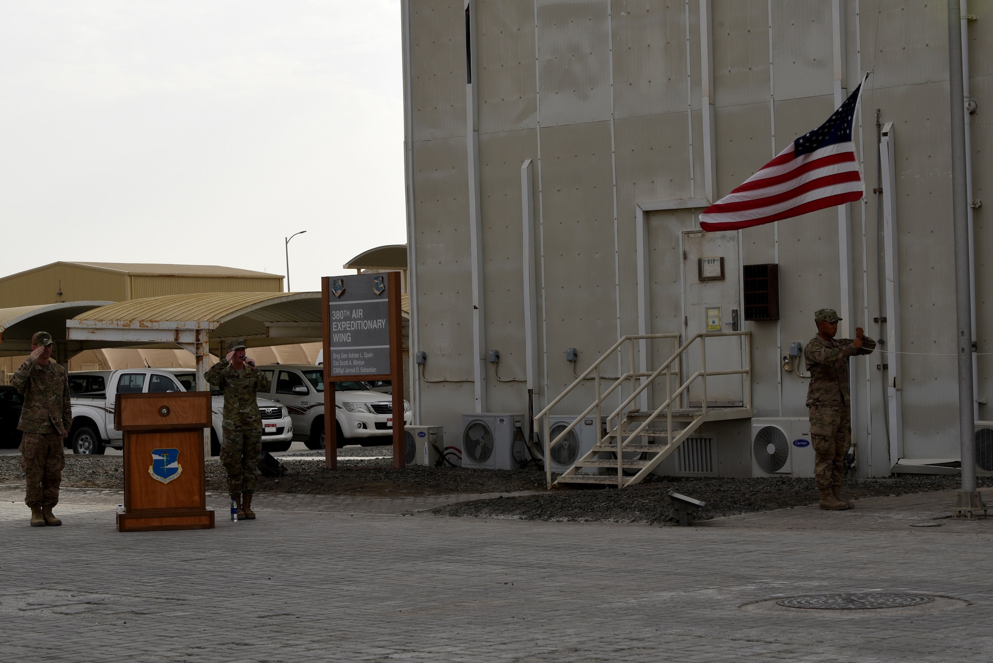 Staff Sgt. Ashley Ihrig, 380th Air Expeditionary Wing, Personnel Support for Contingency Operations NCO in charge and Deliberate and Crisis Action Planning and Execution Segments operator, sings the national anthem as the American flag is lowered during a monthly ceremony on Al Dhafra Air Base, United Arab Emirates, April 5, 2019.