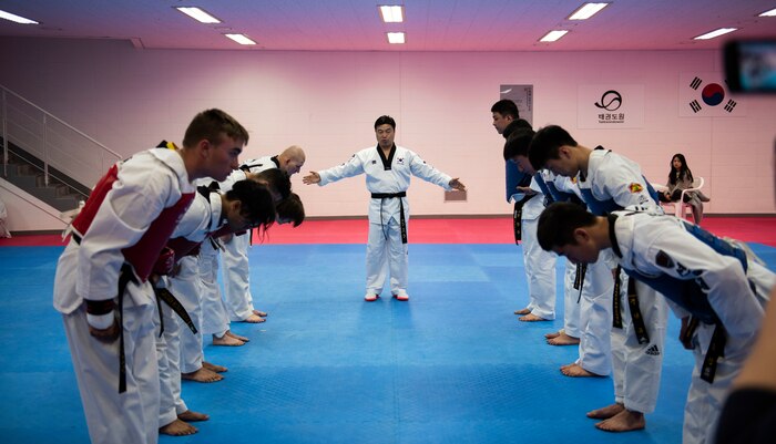 Members from the United States Forces-Korea and Republic of Korea Army soldiers bow before a sparring match during a Korean Ministry of Defense tour at Muju, Republic of Korea, April 9, 2019. The MND Taekwondo camp gave U.S. service members a chance to practice Taekwondo and learn about its history and importance to Korean culture. (U.S. Air Force photo by Senior Airman Stefan Alvarez)