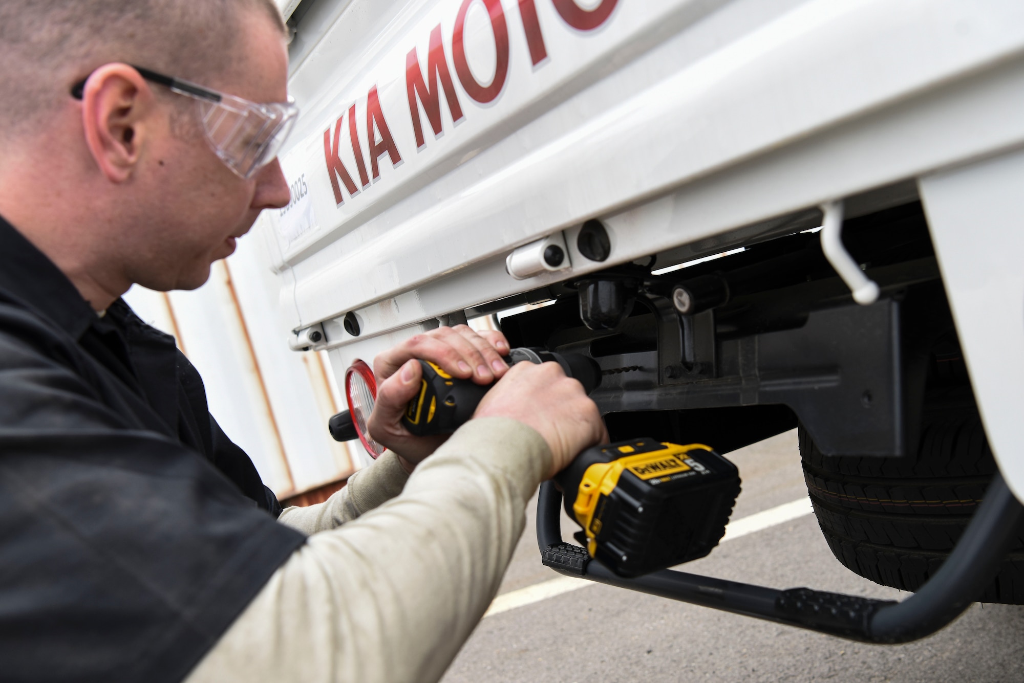 U.S. Air Force Staff Sgt. Joey Hines, 8th Logistics Readiness Squadron vehicle management supervisor, installs license plates on brand new vehicles at Kunsan Air Base, Republic of Korea, April 9, 2019. Eight units at Kunsan are receiving the vehicles, guaranteeing pivotal increased mission capability. (U.S. Air Force photo by Senior Airman Savannah L. Waters)