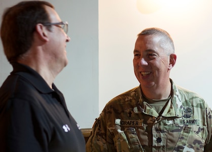 Chaplain (Lt. Col.) Bill Draper of the Kentucky Joint Force Headquarters shares a quick laugh with Keith Wichmann of the John Hopkins Applied Physics Laboratory after a lecture at Cyber Shield 19 held at Camp Atterbury, Ind., April 8, 2019.  Draper was enlisted in the Army for 18 years before starting his career as a chaplain in 2004; he has 37 years of service.