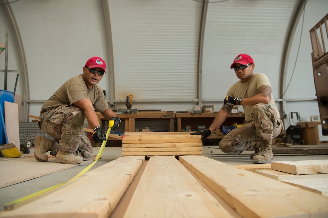 Tech. Sgt. Alexander Nunez, left, 557th Expeditionary RED HORSE Squadron air transportation NCO in charge, and Tech. Sgt. William Nicholas, right, 557th ERHS air transportation augmentee, construct an approach shoring at Al Udeid Air Base, Qatar, April 4, 2019. Nunez and Nicholas are responsible for facilitating air transportation for engineering assets needed across U.S. Central Command (CENTCOM). Logistics Airmen were vital in the completion of more than 400 construction missions across the CENTCOM Theater during a six-month period. (U.S. Air Force photo by Tech. Sgt. Christopher Hubenthal)