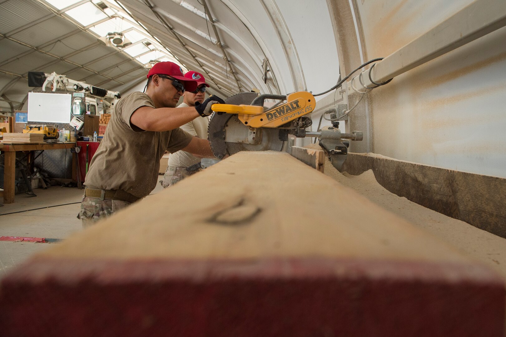 Tech. Sgt. Alexander Nunez, foreground, 557th Expeditionary RED HORSE Squadron air transportation NCO in charge, and Tech. Sgt. William Nicholas, background, 557th ERHS air transportation augmentee, construct an approach shoring at Al Udeid Air Base, Qatar, April 4, 2019. Nunez and Nicholas are responsible for facilitating air transportation for engineering assets needed across U.S. Central Command (CENTCOM). Logistics Airmen were vital in the completion of more than 400 construction missions across the CENTCOM Theater during a six-month period. (U.S. Air Force photo by Tech. Sgt. Christopher Hubenthal)