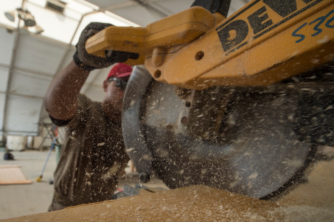 Tech. Sgt. Alexander Nunez, 557th Expeditionary RED HORSE Squadron air transportation NCO in charge, cuts wood during the construction of an approach shoring at Al Udeid Air Base, Qatar, April 4, 2019. Nunez is responsible for facilitating air transportation for engineering assets needed across U.S. Central Command (CENTCOM). Logistics Airmen were vital in the completion of more than 400 construction missions across the CENTCOM Theater during a six-month period. (U.S. Air Force photo by Tech. Sgt. Christopher Hubenthal)