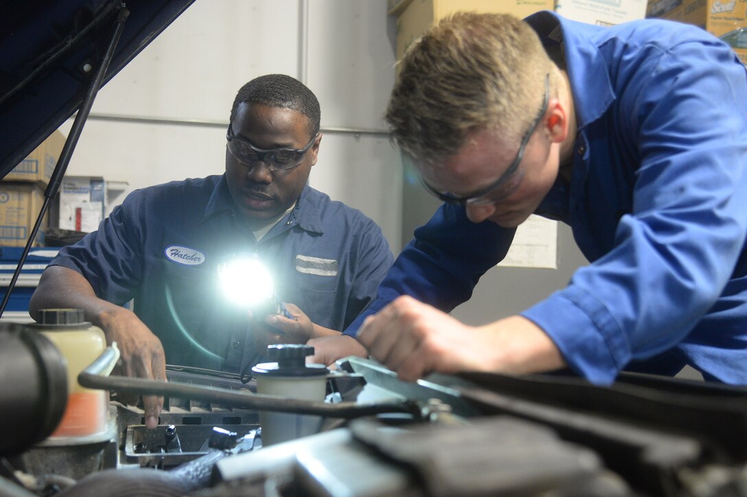 Staff Sgt. Willie Hatcher, 341st Logistics Readiness Squadron firetruck and refueler maintenance apprentice, left, and Airman 1st Class Joshua Byers, 341st LRS vehicle mechanic, examine the engine bay of a fleet vehicle April 9, 2019, at Malmstrom Air Force Base, Mont.