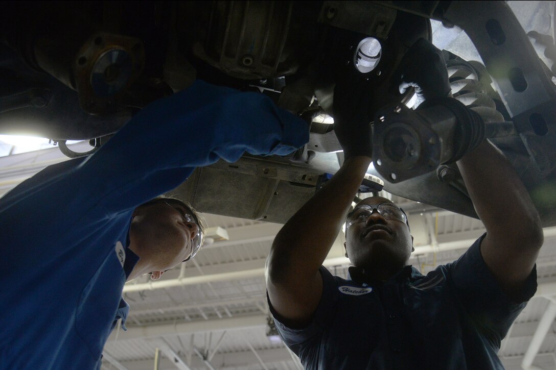 Airman 1st Class Joshua Byers, 341st Logistics Readiness Squadron vehicle mechanic, left, and Staff Sgt. Willie Hatcher, 341st LRS firetruck and refueler maintenance apprentice, examine the underside of a Humvee April 12, 2019, at Malmstrom Air Force Base, Mont.