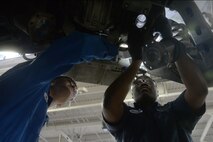 Airman 1st Class Joshua Byers, 341st Logistics Readiness Squadron vehicle mechanic, left, and Staff Sgt. Willie Hatcher, 341st LRS firetruck and refueler maintenance apprentice, examine the underside of a Humvee April 12, 2019, at Malmstrom Air Force Base, Mont.