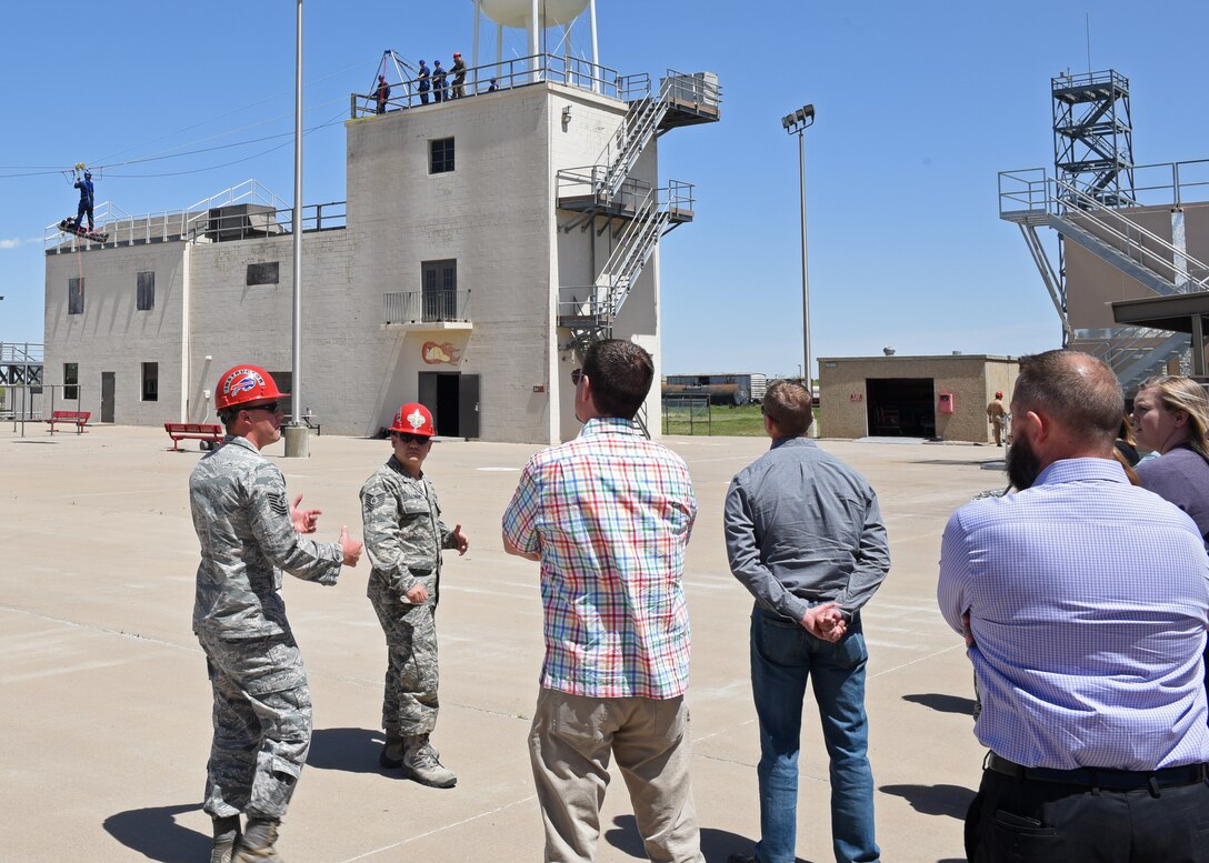 U.S. Air Force Tech. Sgt. Kyle Wirth, 312th Training Squadron instructor, along with Tech. Sgt. Joshua Leonida, 312th TRS instructor, give the Leadership San Angelo class a tour of the Louis F. Garland Department of Defense Fire Academy on Goodfellow Air Force Base, Texas, April 11, 2019. During the tour of the Fire Academy guests were able to see the different branches working together to learn the skills needed to fight any fire threat they may face. (U.S. Air Force photo by Airman 1st Class Zachary Chapman/Released)
