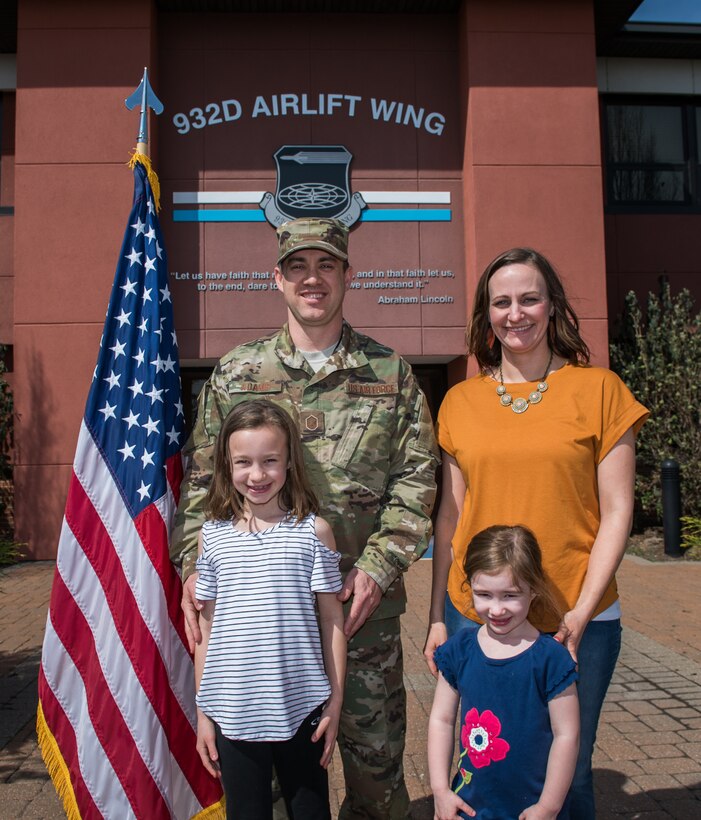 Master Sgt. Eric Adams, 932nd Airlift Wing flight safety noncommissioned officer in charge, is joined by his family following an outdoor enlistment ceremony April 7, 2019, Scott Air Force Base, Illinois. (U.S. Air Force photo by Master Sgt. Christopher Parr)