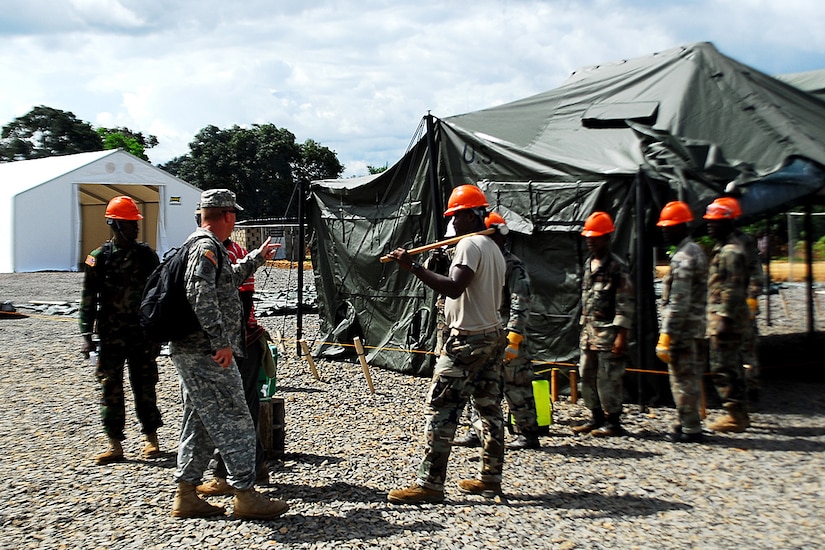 Soldier gives instructions to construction workers