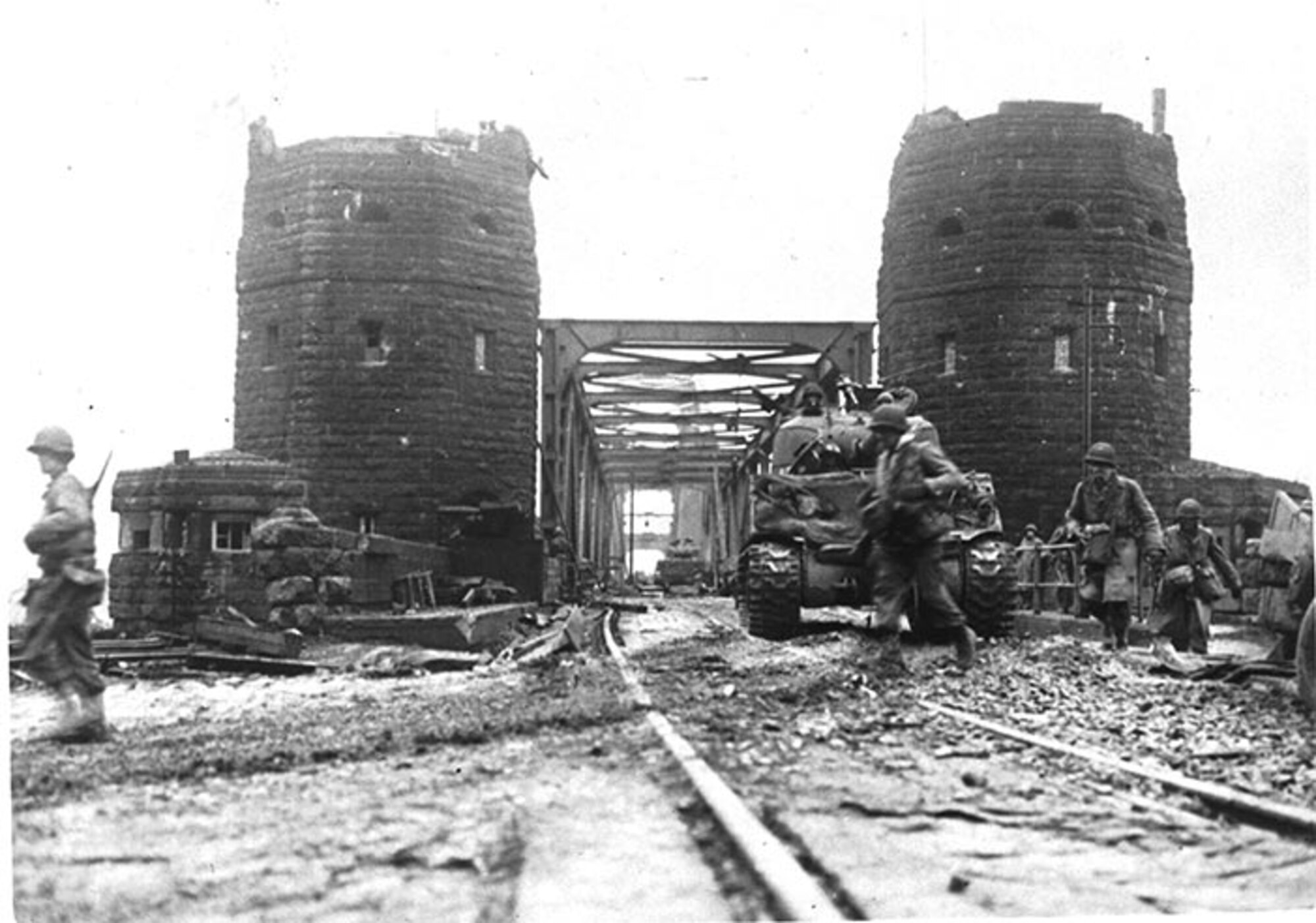 U.S. tanks cross the Ludendorff Bridge 7 March 1945 at Remagen, Germany. The bridge was prepared for demolition but was still intact when the 27th Armored Infantry Battalion arrived at its location. Recognizing the importance of the bridge, battalion leaders acted on their own initiative to change their mission and seize it ten minutes before it was scheduled to be blown up by retreating German forces, ultimately enabling six divisions to cross the bridge and continue the attack before it collapsed on 17 March.