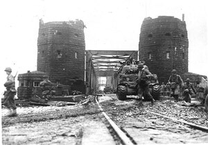 U.S. tanks cross the Ludendorff Bridge 7 March 1945 at Remagen, Germany. The bridge was prepared for demolition but was still intact when the 27th Armored Infantry Battalion arrived at its location. Recognizing the importance of the bridge, battalion leaders acted on their own initiative to change their mission and seize it ten minutes before it was scheduled to be blown up by retreating German forces, ultimately enabling six divisions to cross the bridge and continue the attack before it collapsed on 17 March.