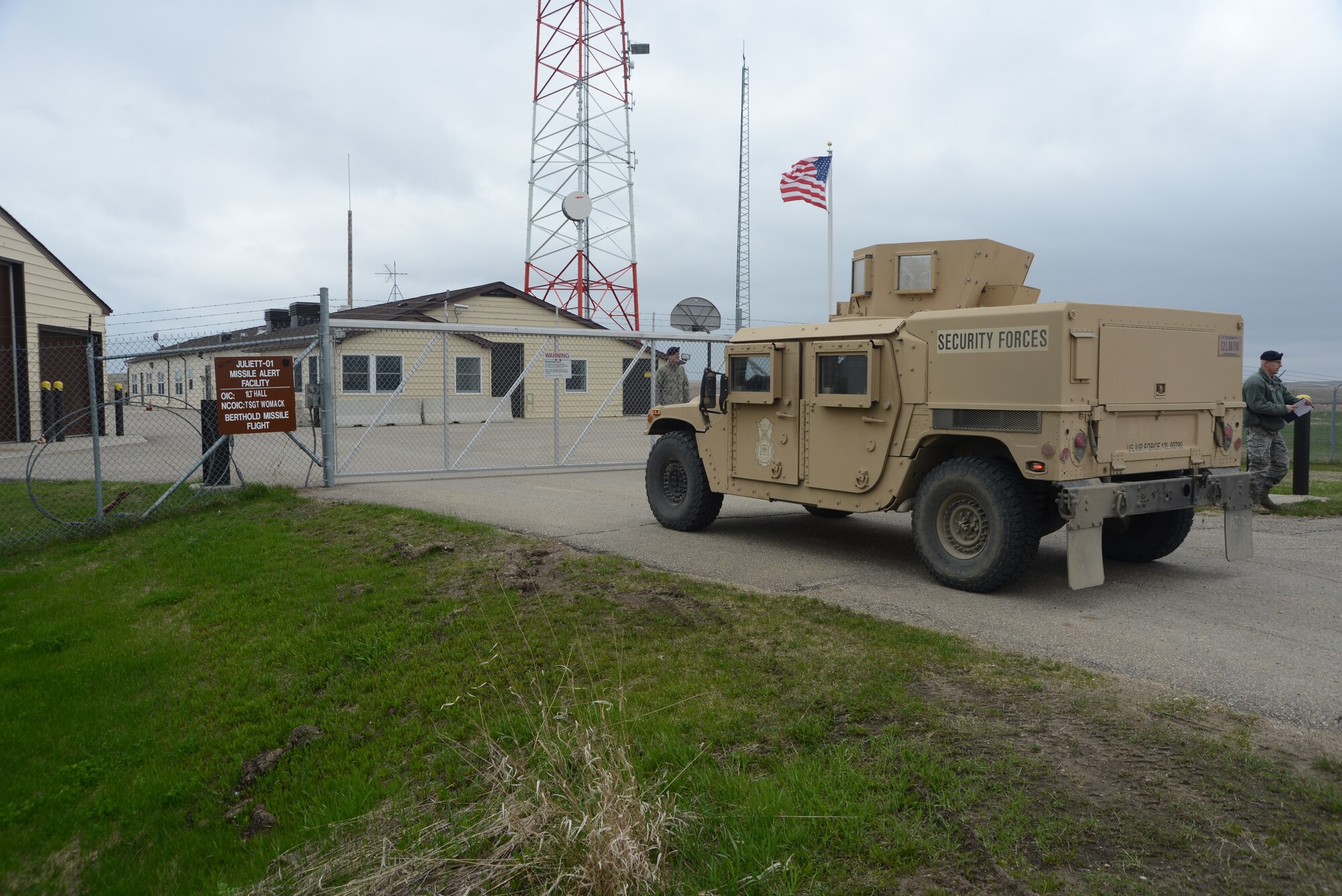 The 219th Security Forces Squadron personnel driving a High Mobility Multipurpose Wheeled Vehicle (HMMWV), commonly known as a Humvee, as they approach the gate of a missile alert facility in the Minot Air Force Base missile field complex near Minot, N.D., May 20, 2014. The 219th Security Forces Squadron personnel are members of the North Dakota Air National Guard doing their annual training while performing the real-World mission of missile field security, which allows their active duty counterparts to catch up on other training and mission requirements.  (U.S. Air National Guard photo by SMSgt. David H. Lipp)