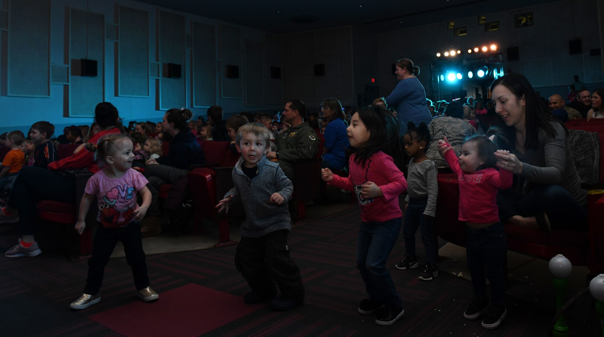 Children dance during a performance of Sesame Street Live at the base theater on Ellsworth Air Force Base, S.D., March 28, 2019.  Families were able to get up close and personal with their favorite characters while singing, dancing and learning about the importance of community. (U.S. Air Force photo by Airman 1st Class Christina Bennett)