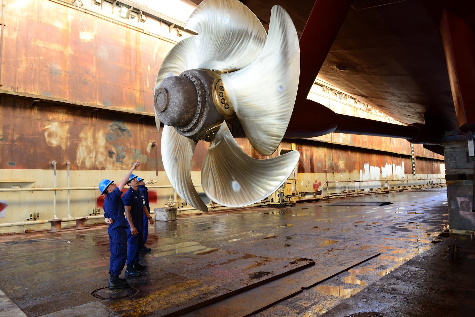 Crewmembers of the Coast Guard Cutter Waesche examine a propellor before the ship leaves drydock in Seattle, Wash., May 22, 2018. The Waesche is a 418-foot Legend-class National Security Cutter homeported in in Alameda, California.